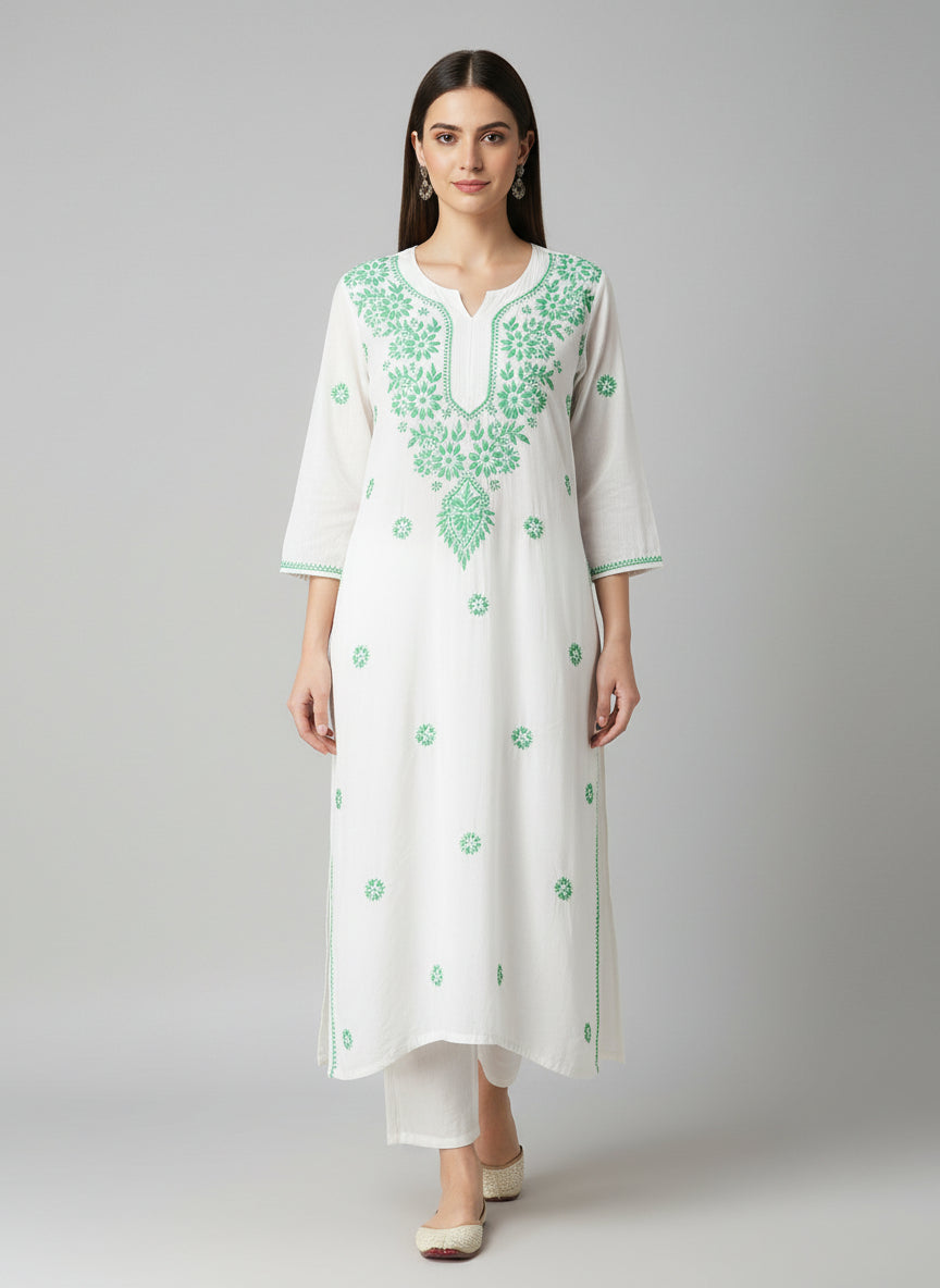A white long kurti with green coloured embroidery 