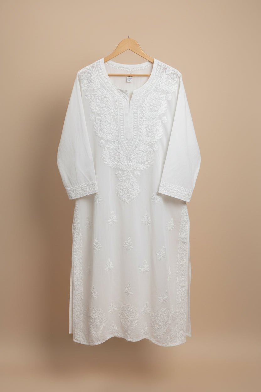  white modal fabric dense Ghasspati embroidered Kurti is displayed in the Famaza Couture Boutique. Focus is the kurti and on it's hand embroidery for the customers to understand the pattern. 