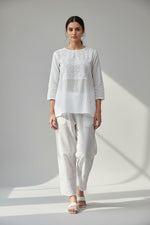 white mulmul fabric straight loose pnats with white hand embroidered with ankle cut design. 