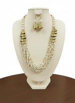 white with golden braided mala jewellery set with gold accents and matching earrings by famaza couture 