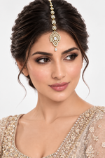 Model wearing Zara gold-tone American diamond maang tikka with an ornate pendant and teardrop accent.